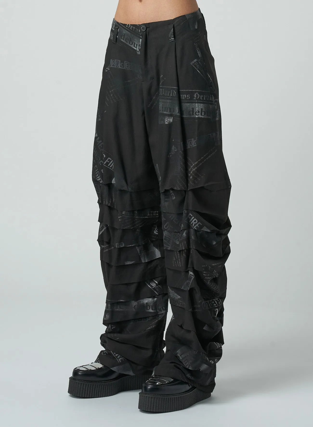 NEWSPAPER PRINT PANTS WITH HORIZONTAL PLEATS