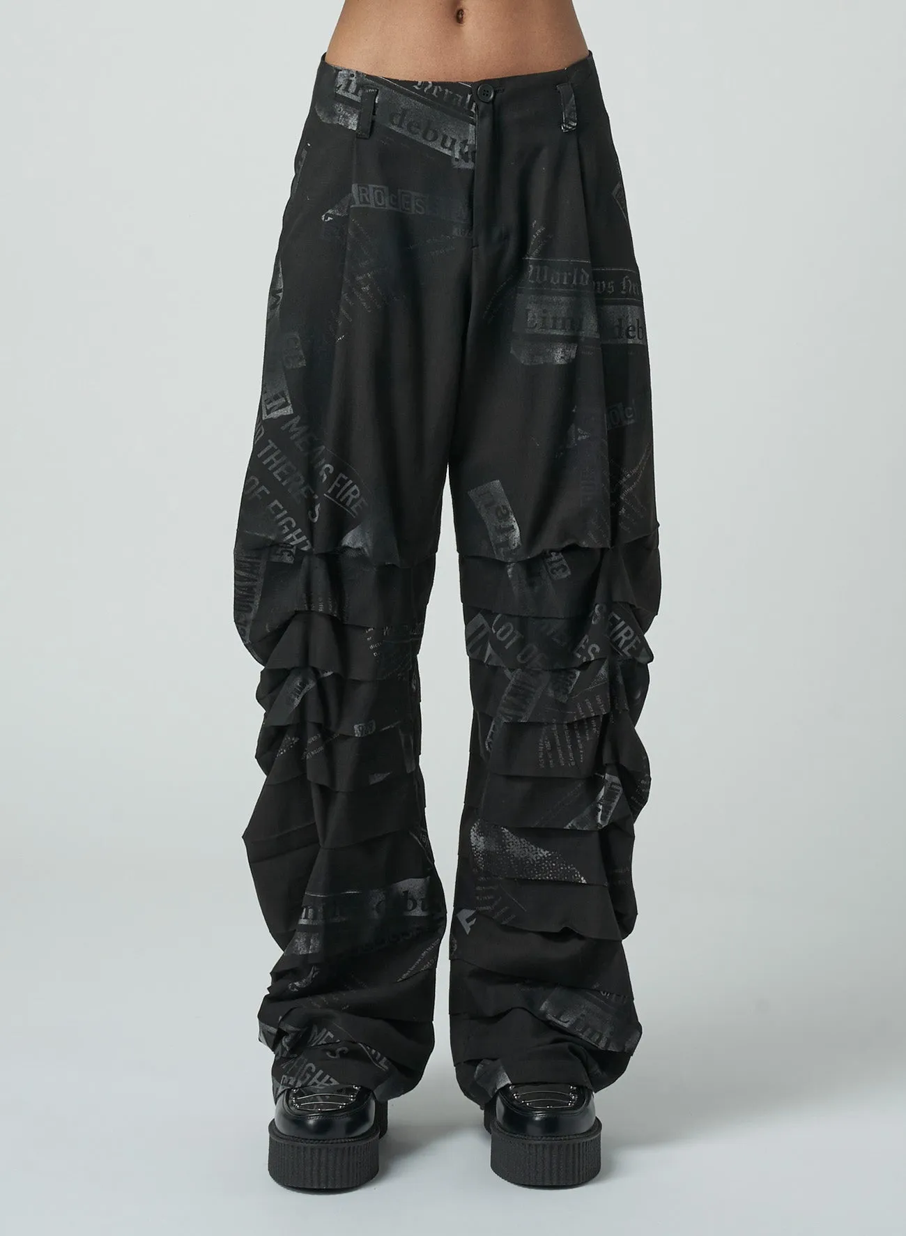 NEWSPAPER PRINT PANTS WITH HORIZONTAL PLEATS