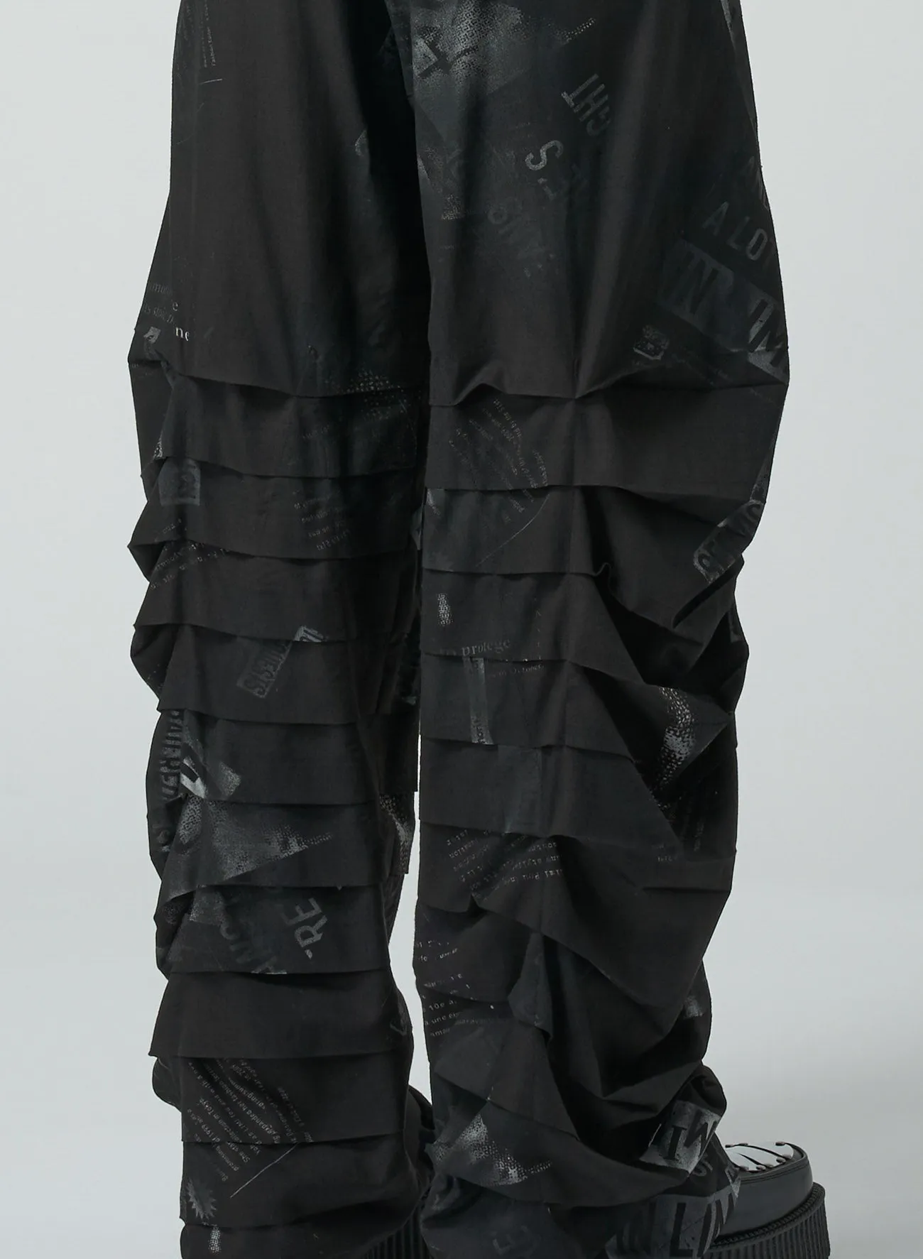 NEWSPAPER PRINT PANTS WITH HORIZONTAL PLEATS